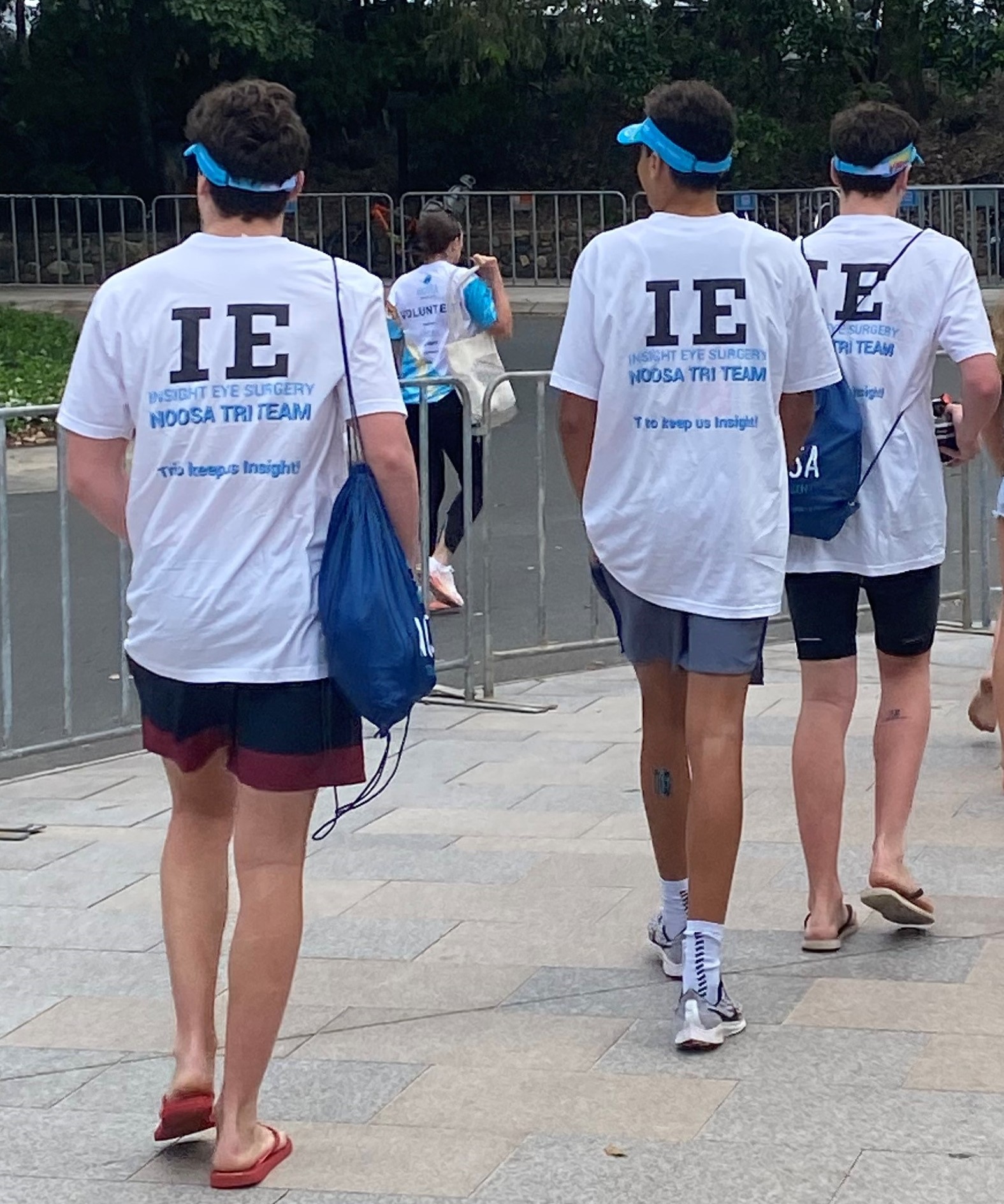 three people from behind wearing IE Noosa Tri Team t shirts